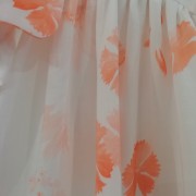 white blouse with little orange flowers and pleats
